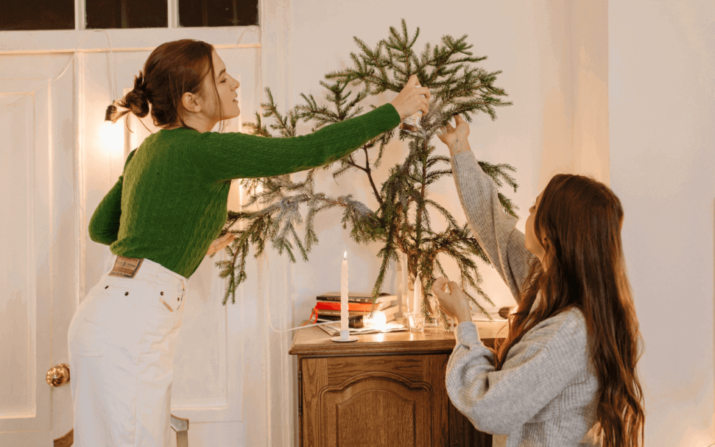 two girls decorating a Christmas tree