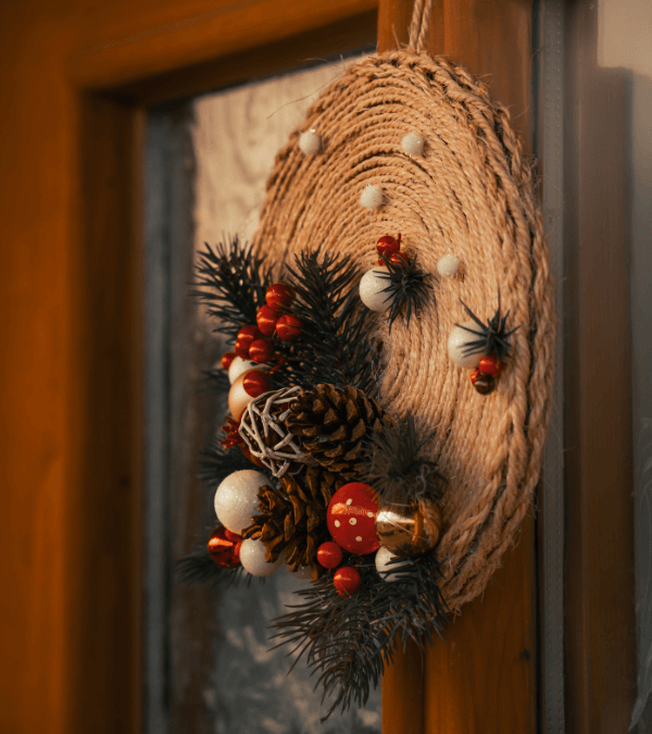 A wreath made with rattan hang on a red window