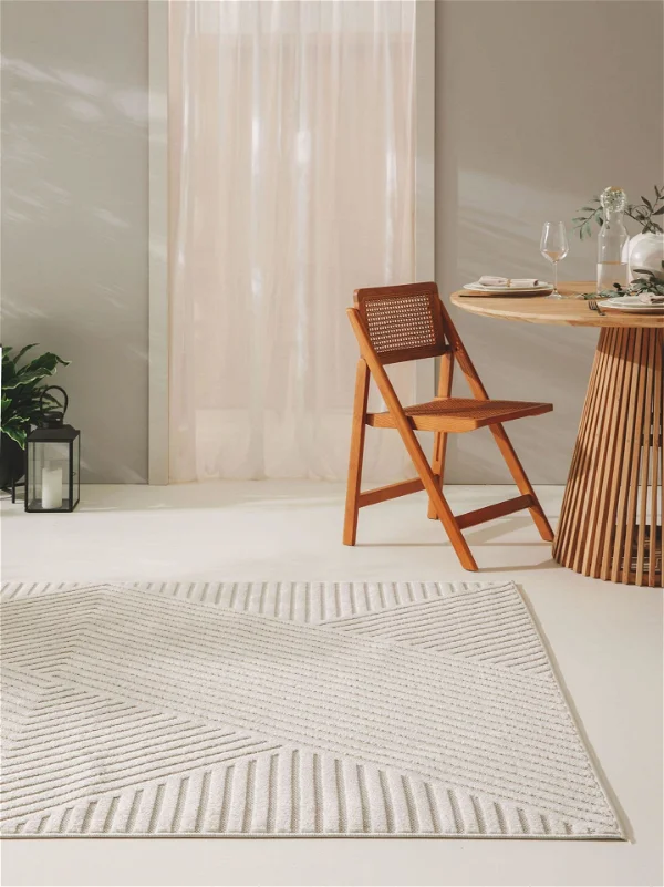 A wooden chair and a carpet in a minimalist deign in beige color
