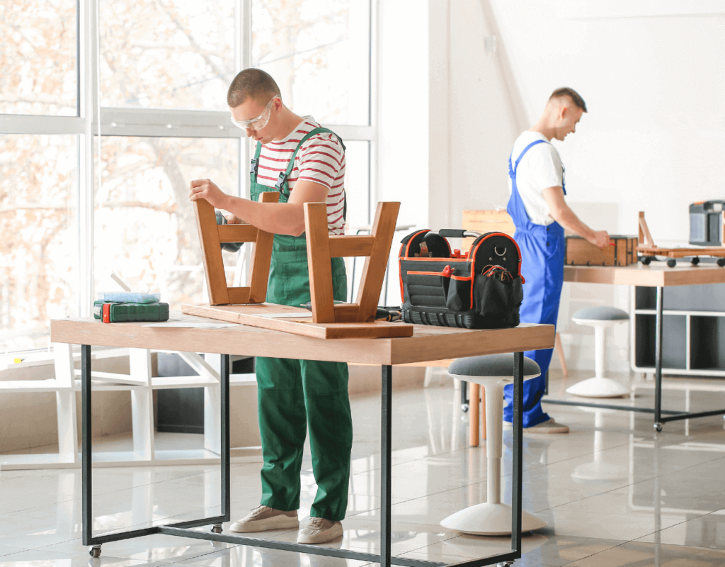 A two male man wearing a green and blue jumper doing a customized furniture