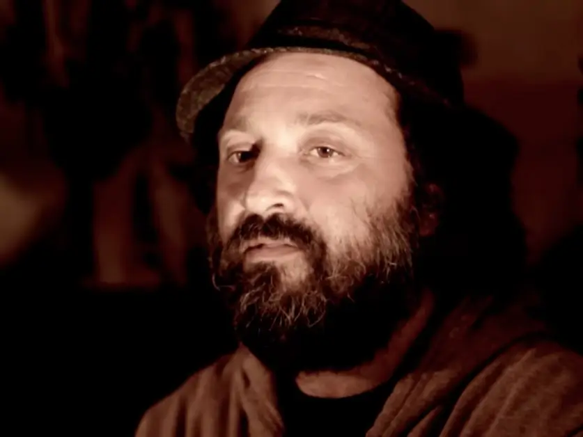 An image of a man with beard and curly hair