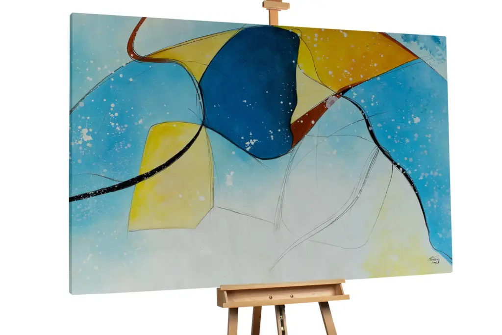 An abstract painting on an easel featuring vibrant blue, yellow, and black fluid shapes against a white background.